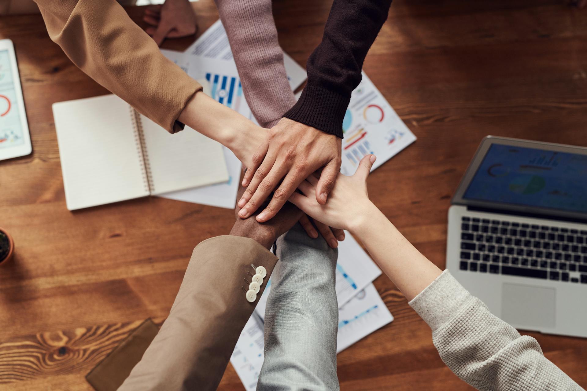 Diverse team collaborating around wooden table