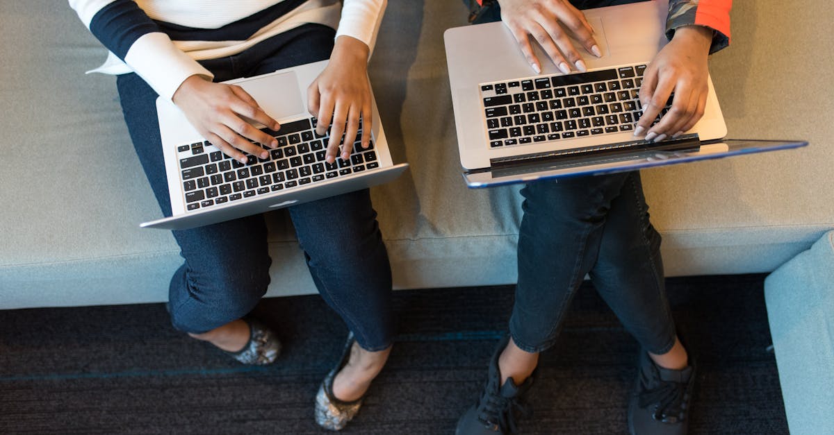 Two professionals reviewing software costs and business tools on a laptop