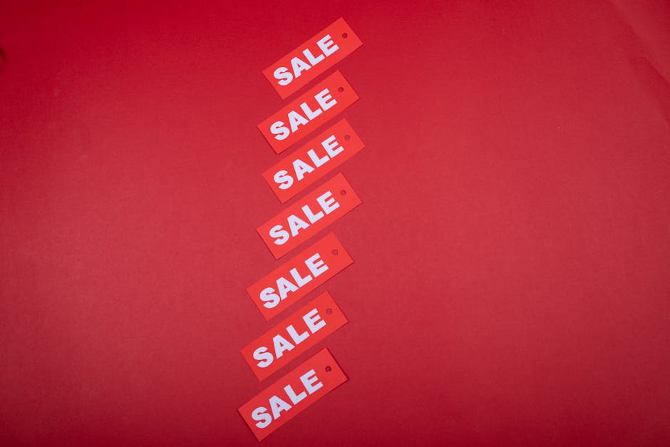 Red sale price tags on dark background representing expensive software pricing