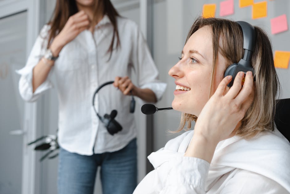 Customer support agent wearing headset smiling while assisting customers via live chat