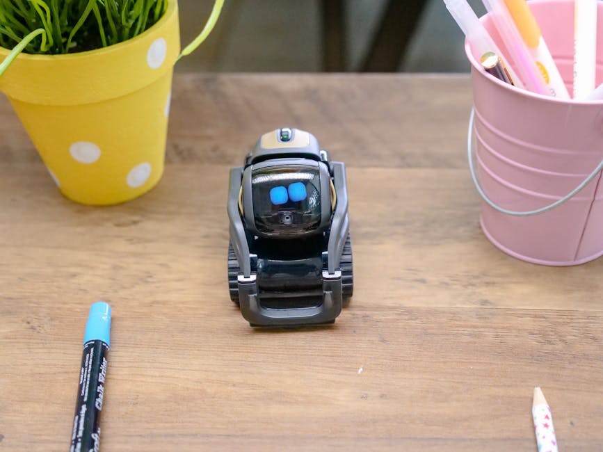 Small modern robot toy on wooden desk representing AI assistant technology