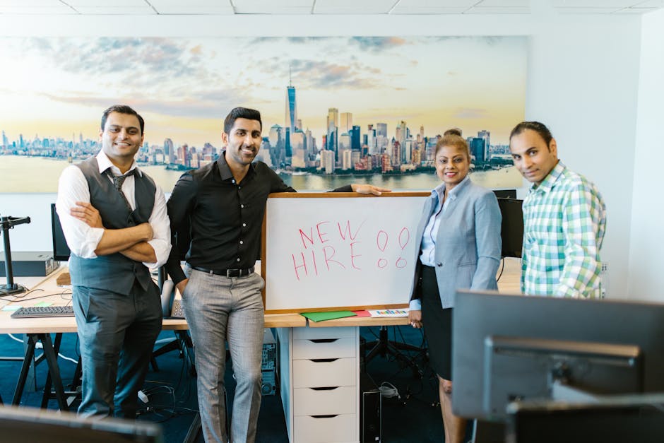 Diverse team standing beside a New Hire sign, representing fast and successful team onboarding