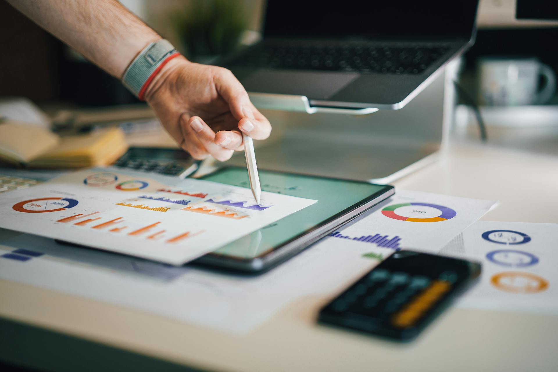Business analytics and cost savings data visualization on tablet