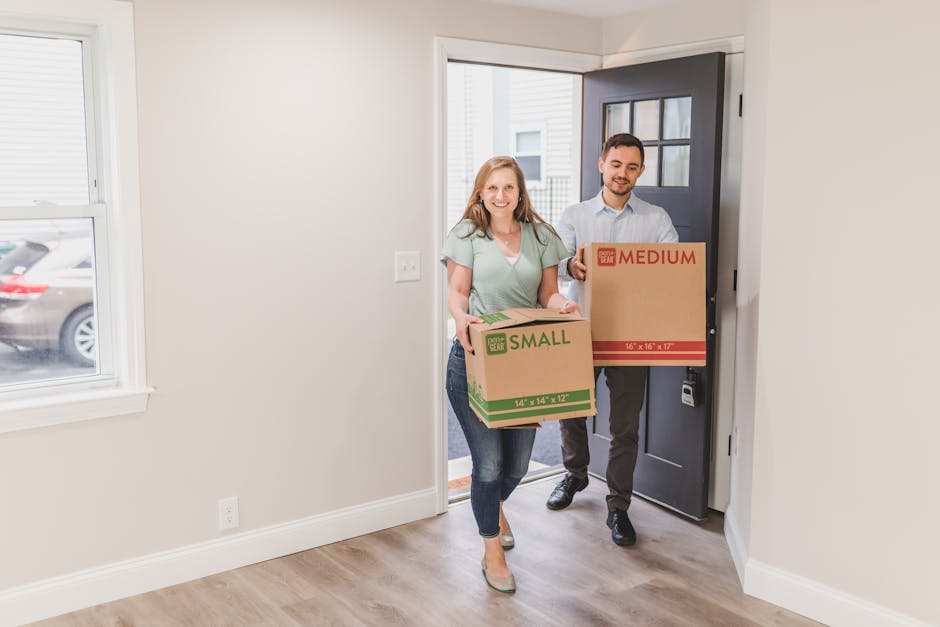 Couple carrying boxes into their new home symbolizing a fresh start