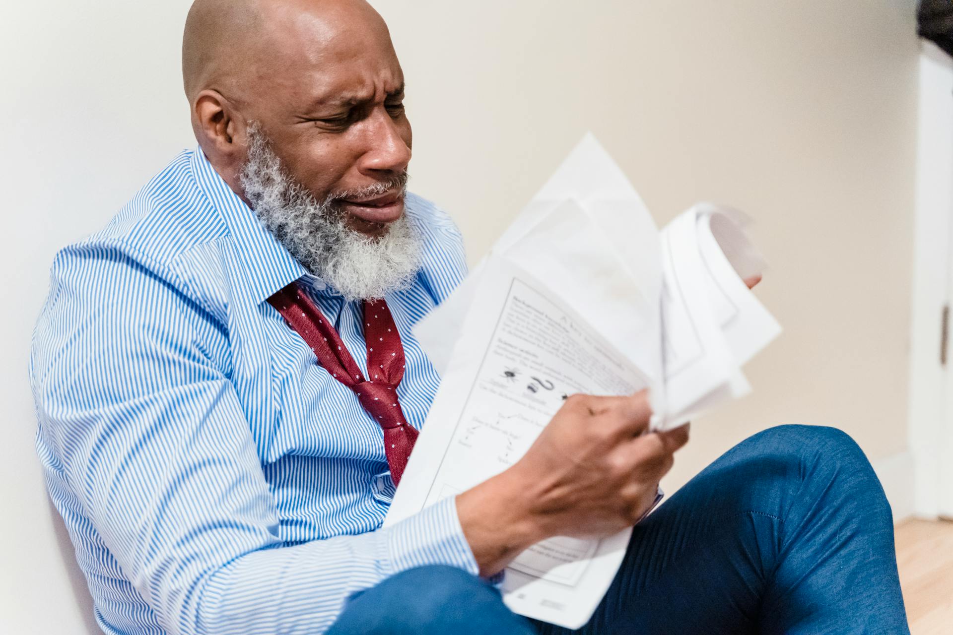 Stressed worker with documents showing customer churn frustration