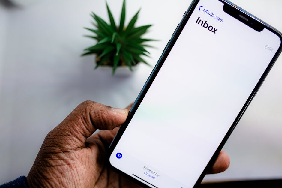 Close-up of smartphone displaying email inbox interface