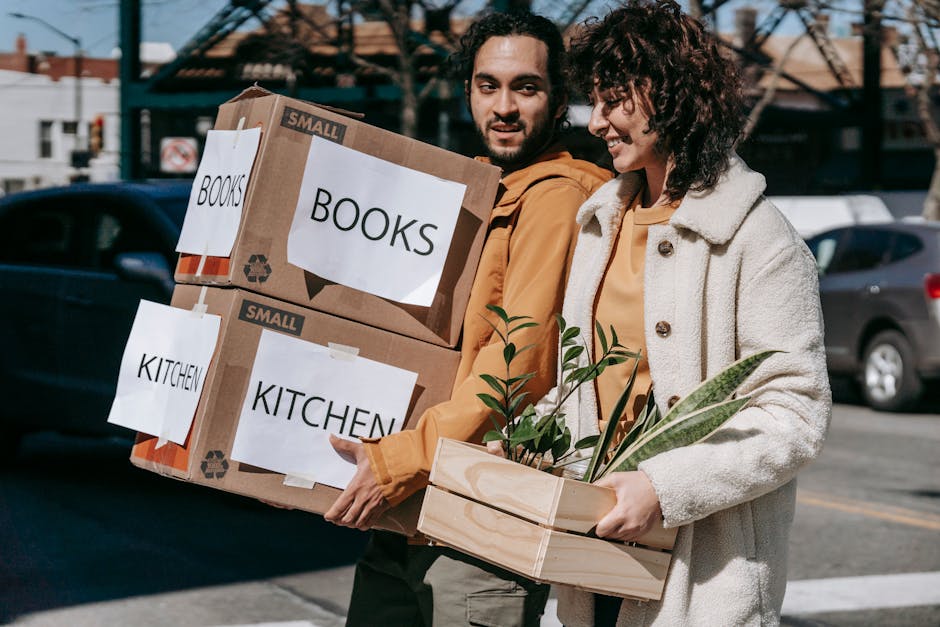 Couple carrying moving boxes representing data migration process