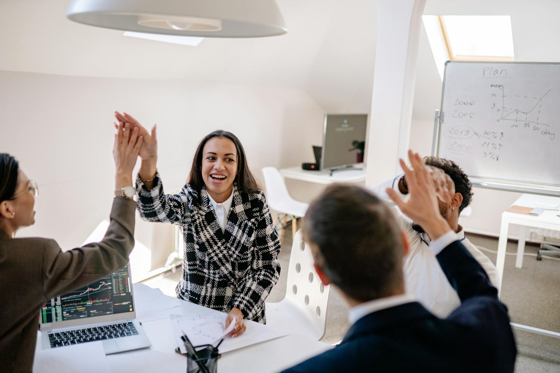 Team celebrating success in modern office