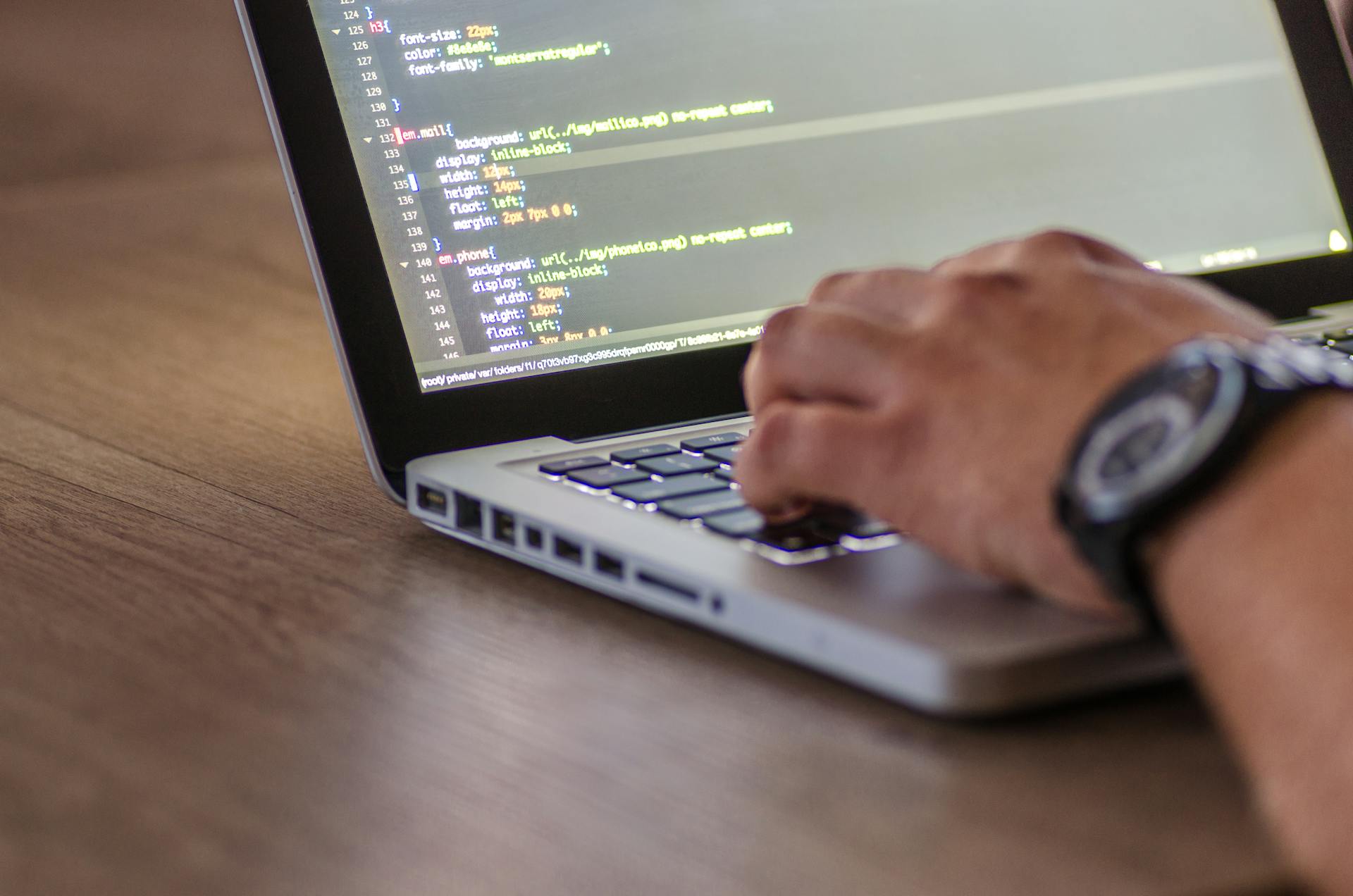 Developer coding on laptop