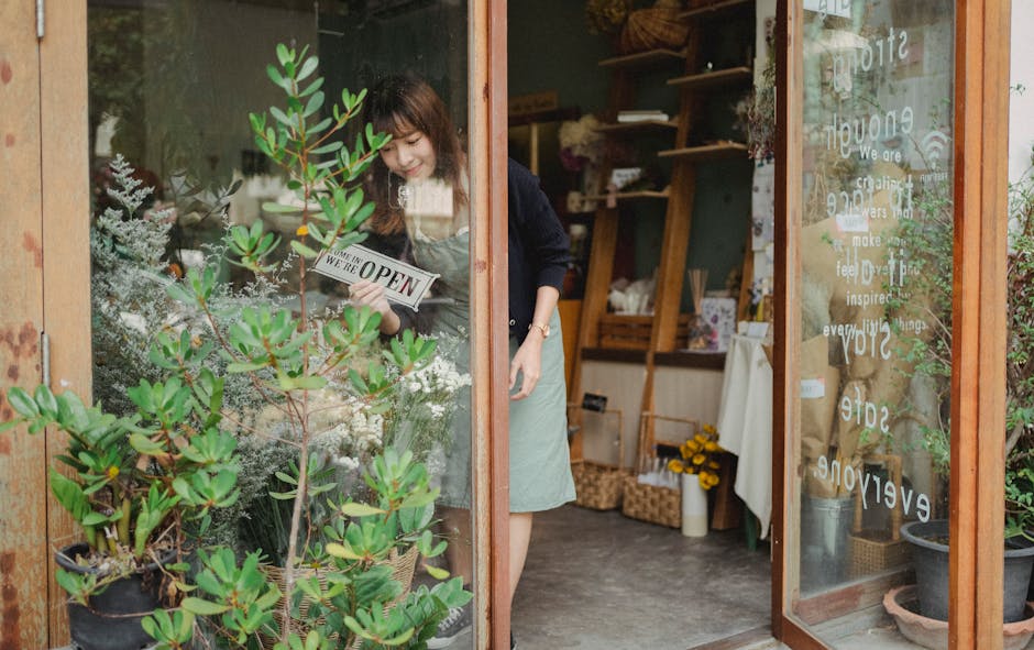 Small business owner at the entrance of her shop, representing the entrepreneurs who benefit most from CRM tools